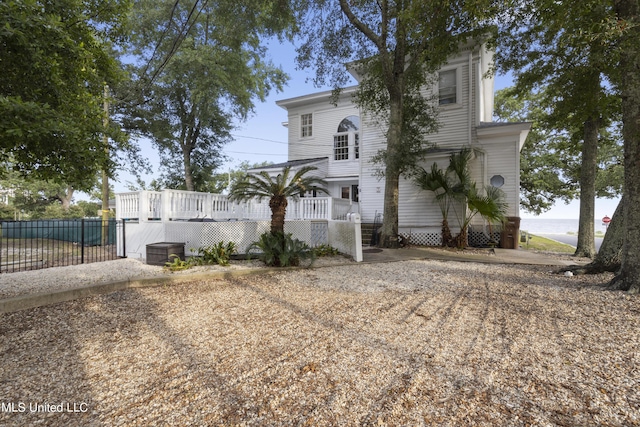view of front facade featuring fence and a deck