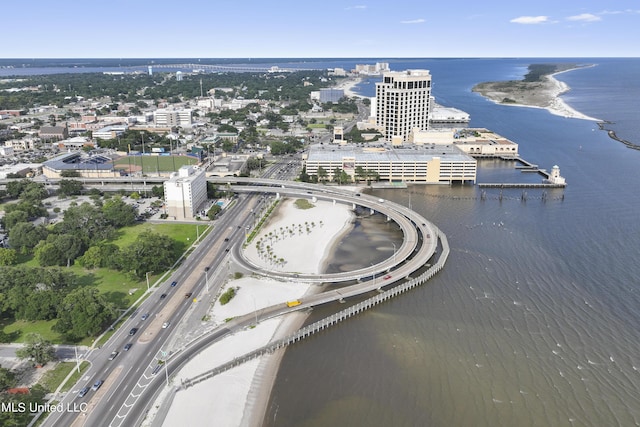 view of urban area featuring a major roadway and a large body of water