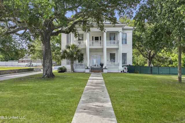 greek revival inspired property with a balcony and a porch