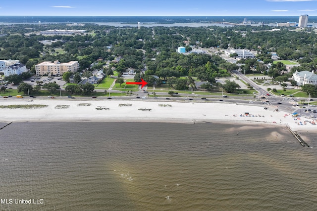 bird's eye view with a water view and a beach view