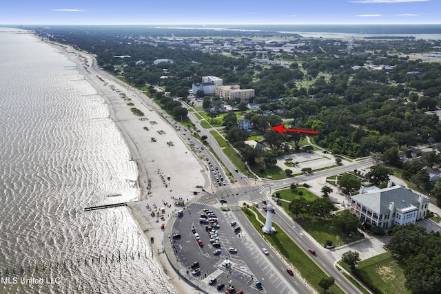 aerial view of property and surrounding area with a nearby body of water and a highway