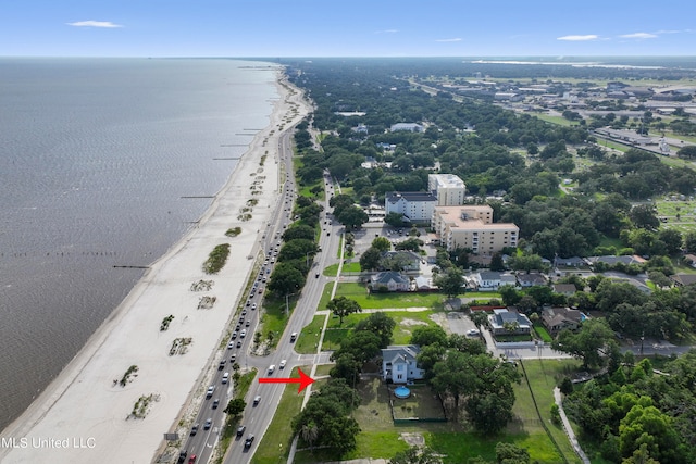 drone / aerial view with a water view and a beach view