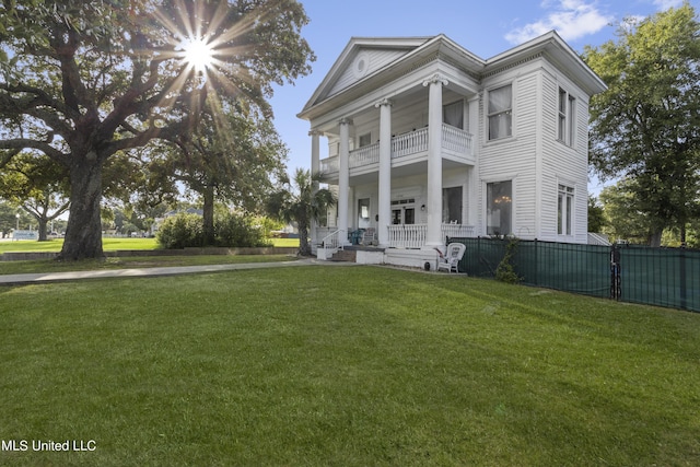 greek revival house with a balcony and covered porch