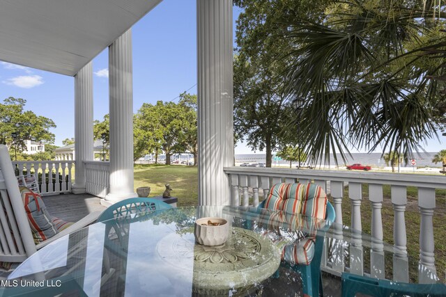 balcony with outdoor dining area and a porch