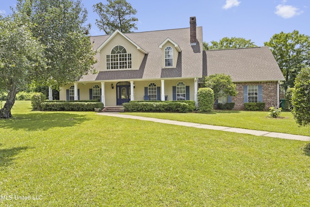 12880 Coles Cv, Gulfport, MS 39503 - view of front facade featuring a chimney, a front lawn, a porch, and roof with shingles