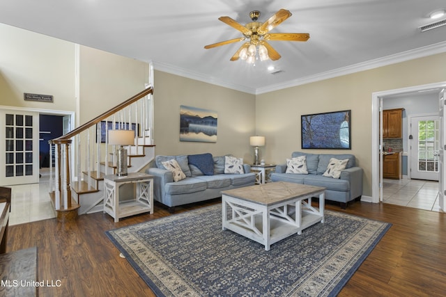 12880 Coles Cv, Gulfport, MS 39503 - living room with ceiling fan, stairway, crown molding, and wood finished floors