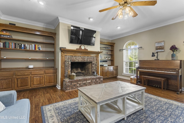 12880 Coles Cv, Gulfport, MS 39503 - living room featuring crown molding, dark wood-style floors, a ceiling fan, a brick fireplace, and baseboards