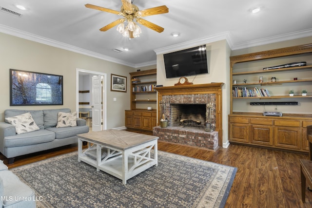 12880 Coles Cv, Gulfport, MS 39503 - living area with crown molding, a ceiling fan, dark wood finished floors, a brick fireplace, and recessed lighting