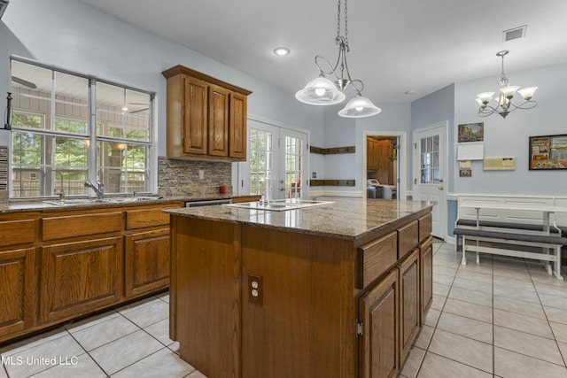 12880 Coles Cv, Gulfport, MS 39503 - kitchen with a sink, a chandelier, a kitchen island, light tile patterned flooring, and recessed lighting