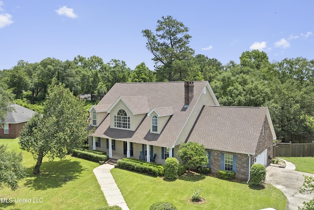 12880 Coles Cv, Gulfport, MS 39503 - view of front facade with driveway, covered porch, a chimney, an attached garage, and roof with shingles