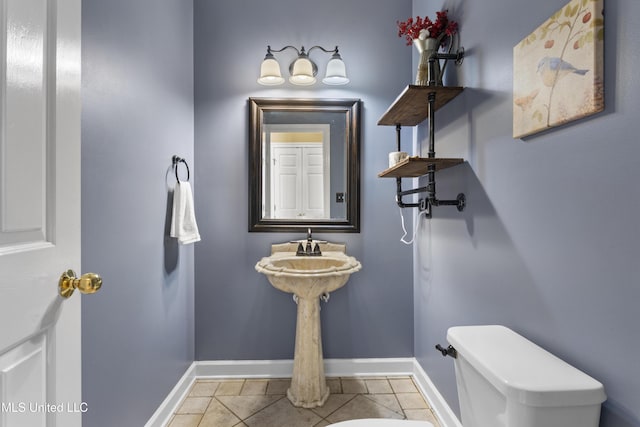 12880 Coles Cv, Gulfport, MS 39503 - bathroom with baseboards, toilet, and tile patterned floors