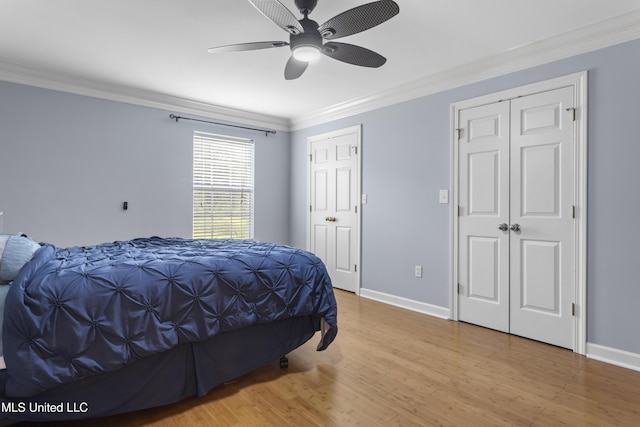 12880 Coles Cv, Gulfport, MS 39503 - bedroom featuring ornamental molding, wood finished floors, baseboards, two closets, and ceiling fan
