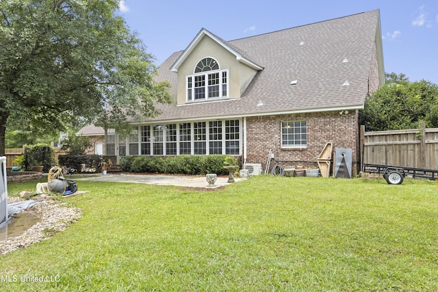 12880 Coles Cv, Gulfport, MS 39503 - rear view of house featuring roof with shingles, brick siding, and a patio area