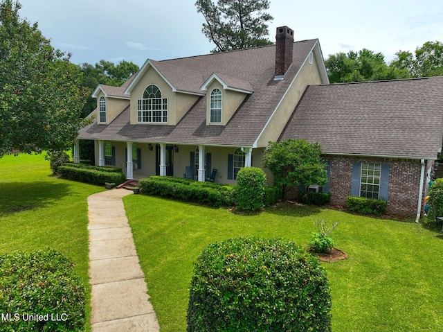 12880 Coles Cv, Gulfport, MS 39503 - cape cod-style house with stucco siding, a porch, roof with shingles, a front yard, and a chimney