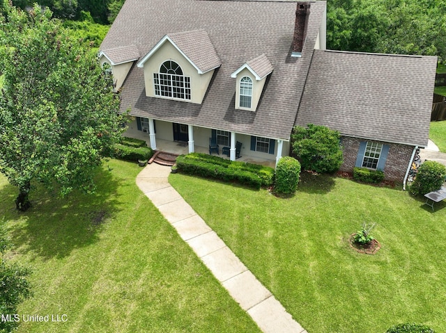 12880 Coles Cv, Gulfport, MS 39503 - view of front facade with covered porch, roof with shingles, a chimney, and a front yard