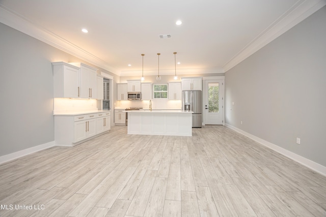 kitchen with light hardwood / wood-style floors, appliances with stainless steel finishes, a center island, and hanging light fixtures