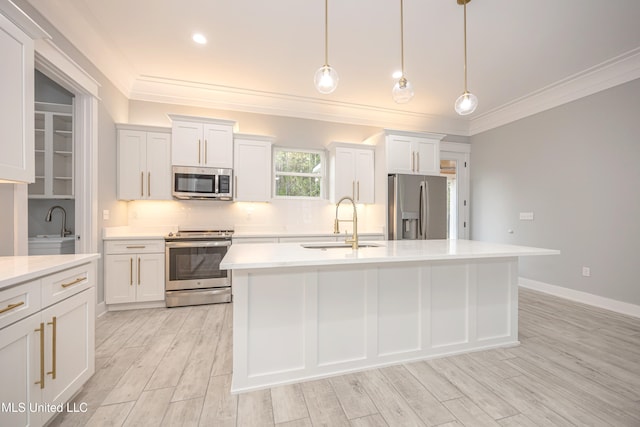 kitchen with white cabinetry, stainless steel appliances, and hanging light fixtures