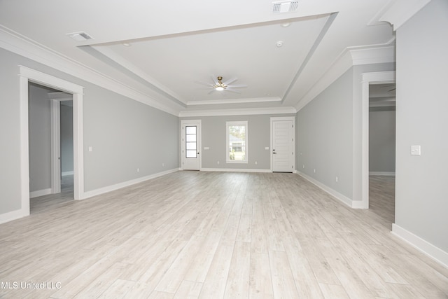 unfurnished living room featuring light hardwood / wood-style flooring, ornamental molding, ceiling fan, and a raised ceiling