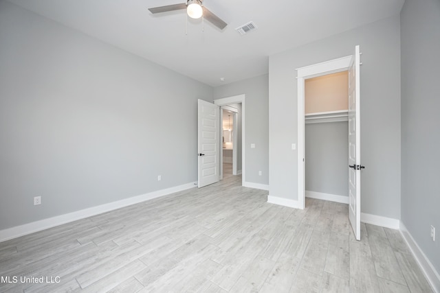 unfurnished bedroom featuring a closet, ceiling fan, and light hardwood / wood-style flooring