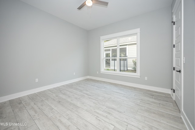 spare room featuring light hardwood / wood-style floors and ceiling fan