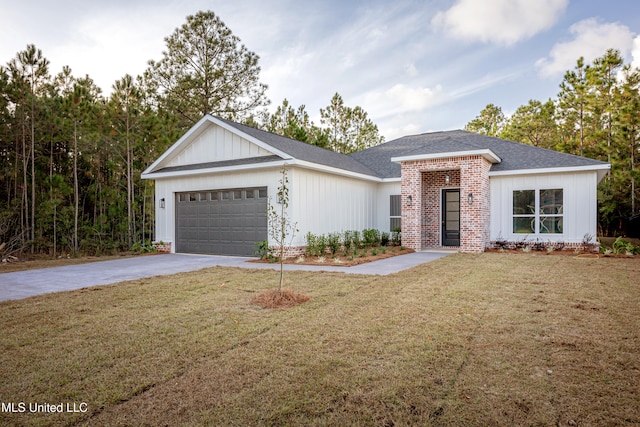 view of front of house with a front yard and a garage