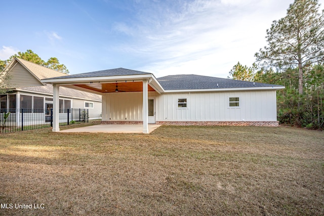 rear view of property featuring a yard, a patio area, and ceiling fan