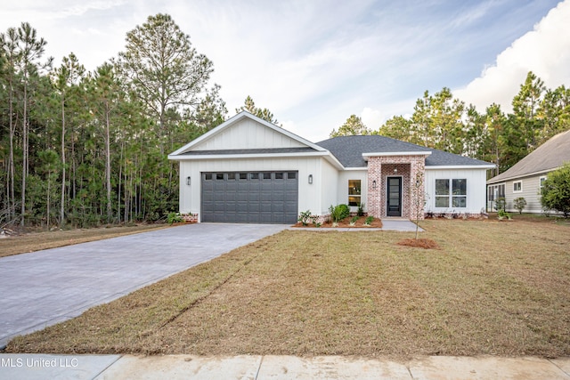 view of front of property featuring a front lawn and a garage