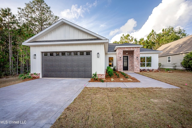 view of front of home with a front yard and a garage