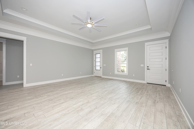 unfurnished room featuring ornamental molding, a tray ceiling, light hardwood / wood-style floors, and ceiling fan