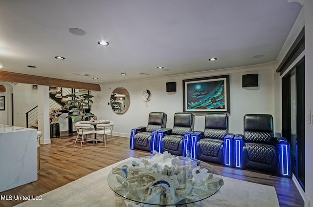 home theater featuring ornamental molding and hardwood / wood-style floors