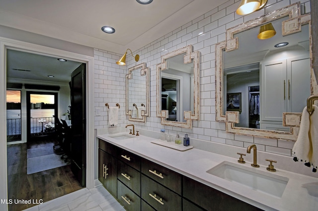 bathroom featuring vanity, hardwood / wood-style flooring, and decorative backsplash