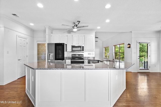 7906 Kirkwood Cv, Olive Branch, MS 38654 - kitchen with stainless steel microwave, refrigerator with ice dispenser, black / electric stove, ceiling fan, and stone counters