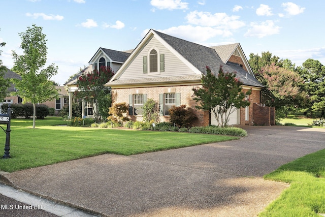 7906 Kirkwood Cv, Olive Branch, MS 38654 - view of front of property with brick siding, driveway, a garage, and a front lawn