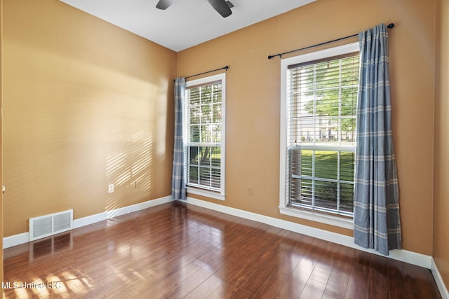 7906 Kirkwood Cv, Olive Branch, MS 38654 - empty room featuring a ceiling fan, plenty of natural light, and wood finished floors