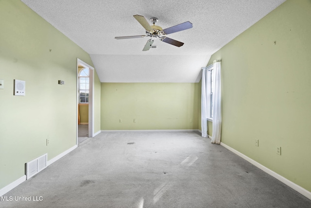 7906 Kirkwood Cv, Olive Branch, MS 38654 - carpeted spare room with lofted ceiling, a ceiling fan, and a textured ceiling