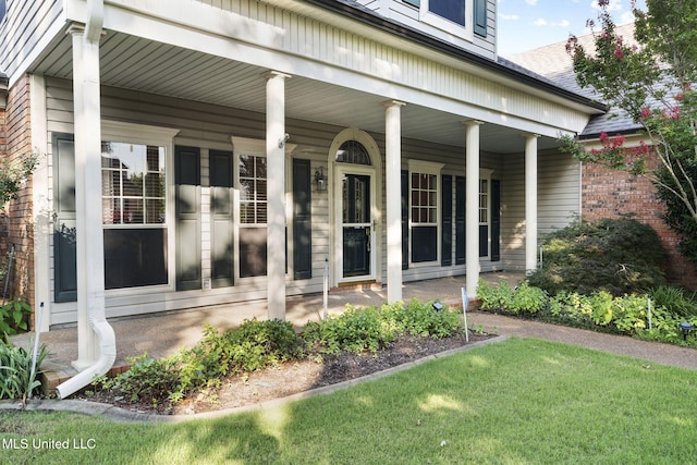 7906 Kirkwood Cv, Olive Branch, MS 38654 - entrance to property featuring a porch, brick siding, a yard, and roof with shingles