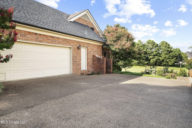 7906 Kirkwood Cv, Olive Branch, MS 38654 - view of home's exterior with driveway, brick siding, and a shingled roof