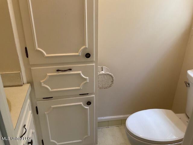 bathroom featuring tile patterned floors, vanity, and toilet