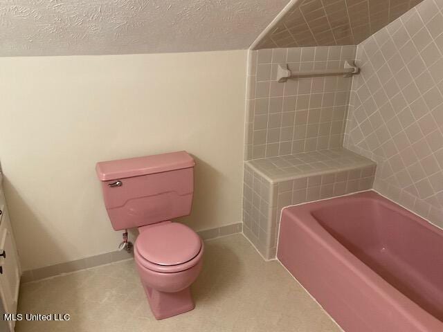 bathroom with a bath, vanity, and toilet