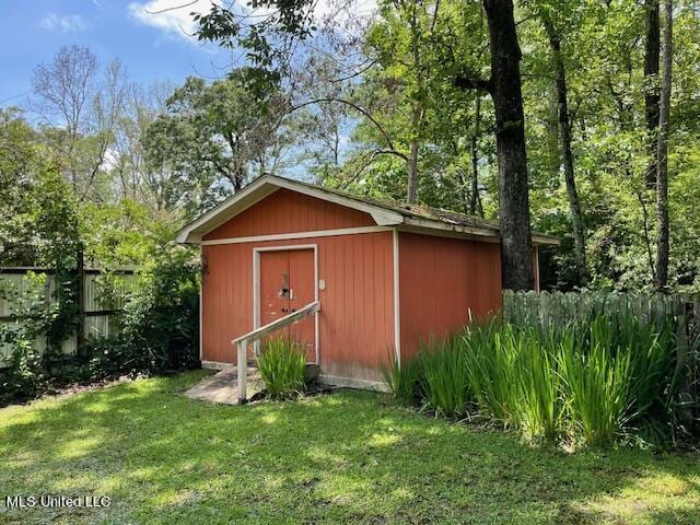 view of outbuilding with a yard