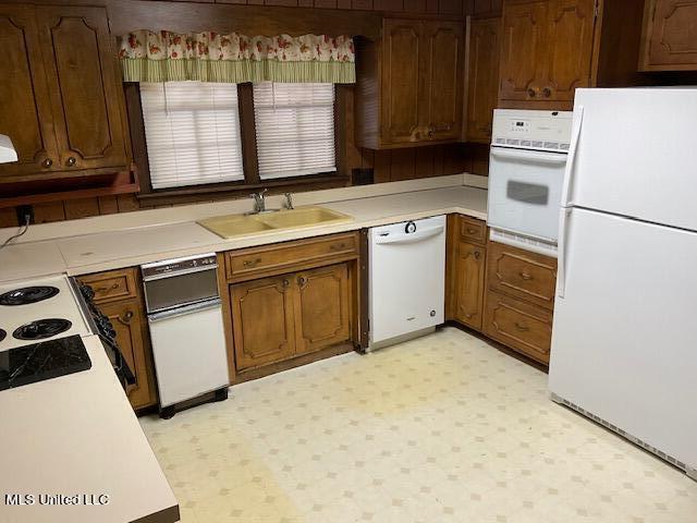 kitchen featuring sink and white appliances