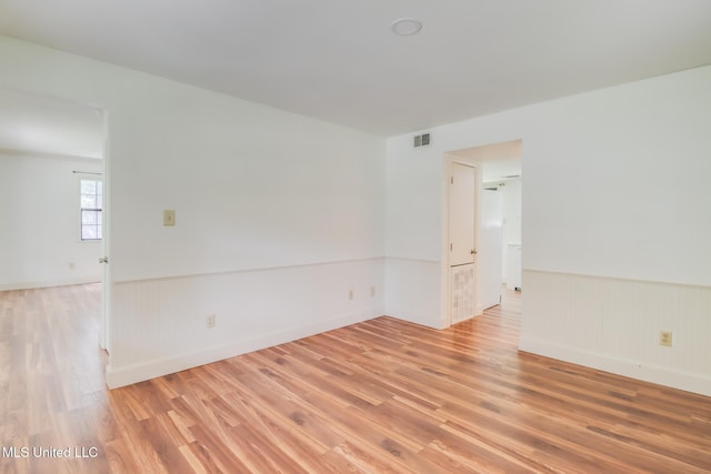 6910 Apuwai Pl, Diamondhead, MS 39525 - spare room featuring light wood-type flooring and a wainscoted wall