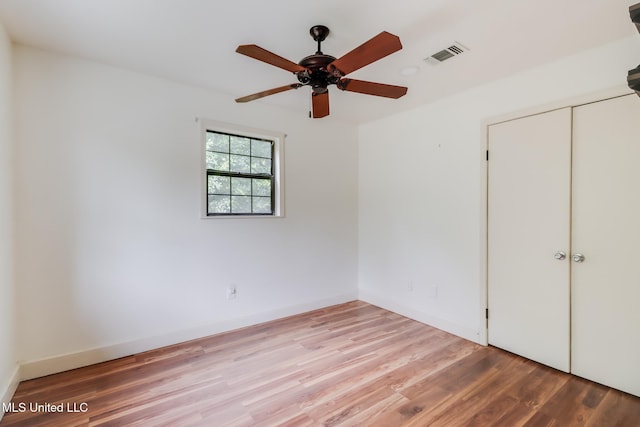6910 Apuwai Pl, Diamondhead, MS 39525 - unfurnished bedroom featuring light wood finished floors, a closet, and ceiling fan