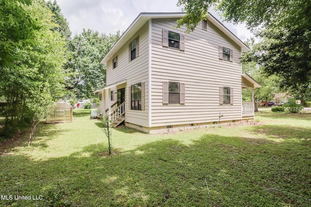 6910 Apuwai Pl, Diamondhead, MS 39525 - rear view of property with a greenhouse, crawl space, a yard, an outbuilding, and entry steps