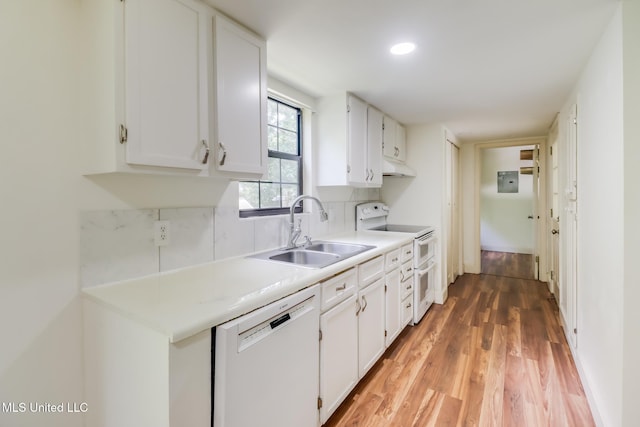6910 Apuwai Pl, Diamondhead, MS 39525 - kitchen featuring white appliances, under cabinet range hood, light wood-style floors, white cabinets, and light countertops