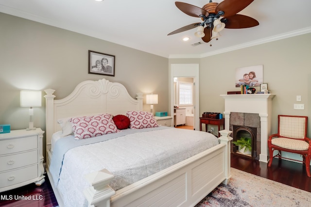bedroom with dark wood-type flooring, ornamental molding, a tile fireplace, recessed lighting, and baseboards