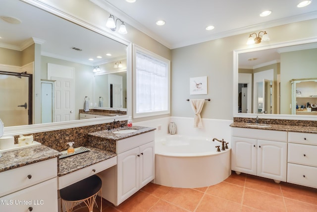 bathroom featuring ornamental molding, a garden tub, a shower stall, tile patterned flooring, and two vanities
