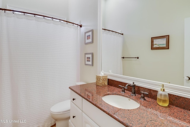 bathroom featuring toilet and vanity