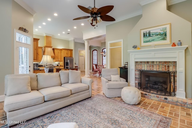 living area with decorative columns, ornamental molding, recessed lighting, a ceiling fan, and a fireplace