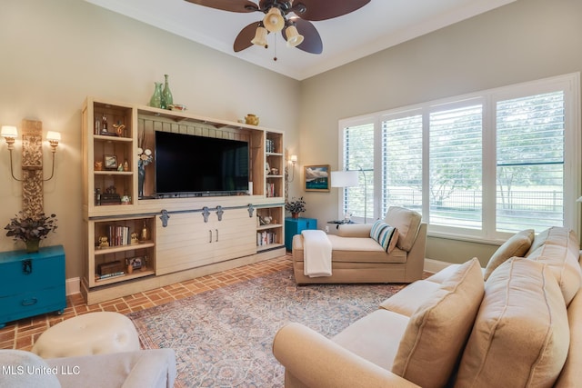 living room with ceiling fan and baseboards